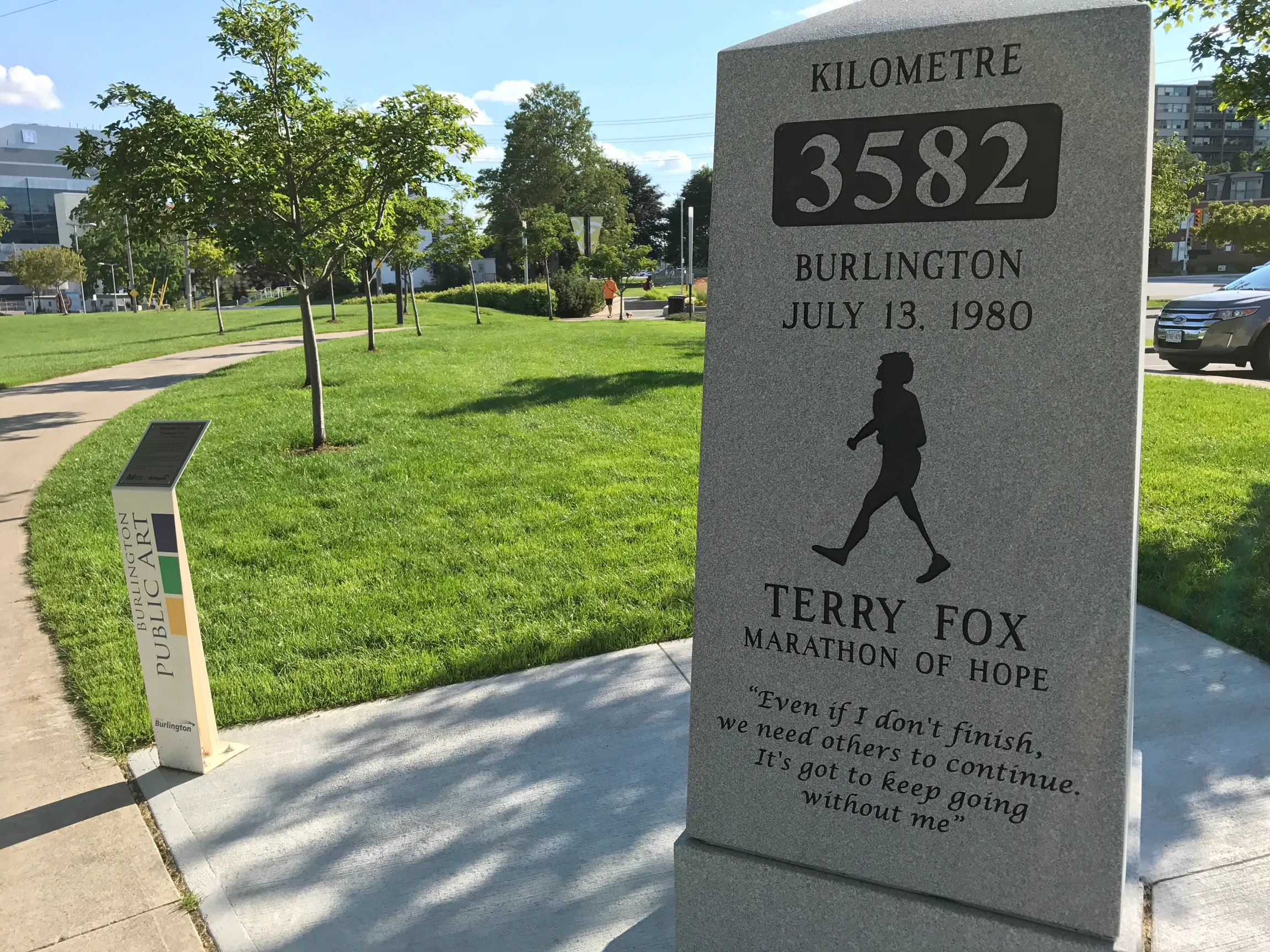A pale granite marker engraved KILOMETRE 3582, BURLINGTON, JULY 13 1980, with a figure of Terry Fox running and his words carved beneath it.